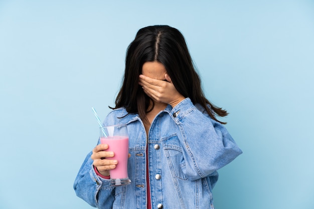 Молодая женщина с клубничным молочным коктейлем