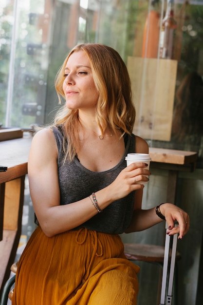 Young woman with suitcase on her coffee break