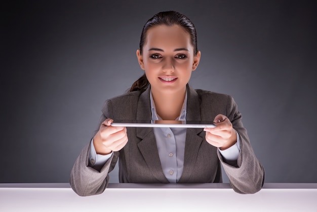 Young woman with tablet in business concept