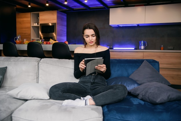 Young woman with tablet pc on the sofa