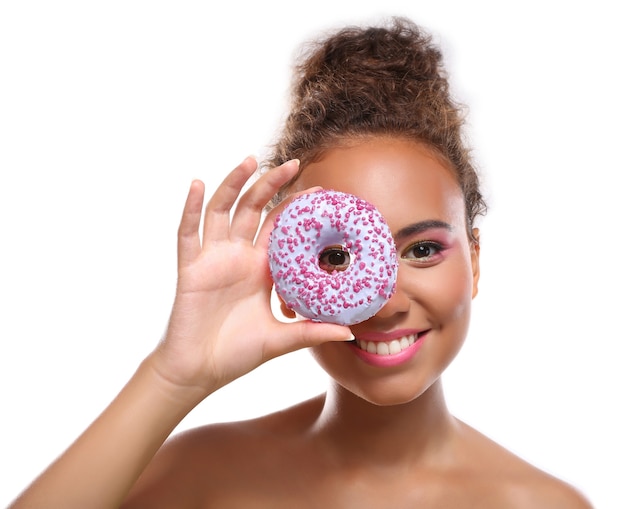 Young woman with tasty doughnut