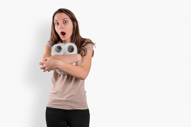 Young woman with toilet paper rolls background