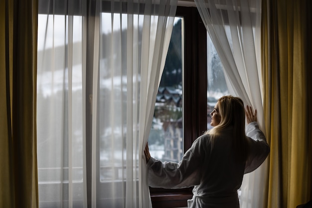 Young woman with a view of the winter mountain landscape