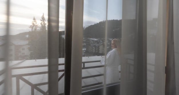 Young woman with a view of the winter mountain landscape