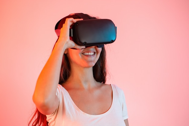 Young woman with virtual reality headset on eyes smiling from close up