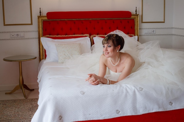 Young woman with wedding dress in very bright room