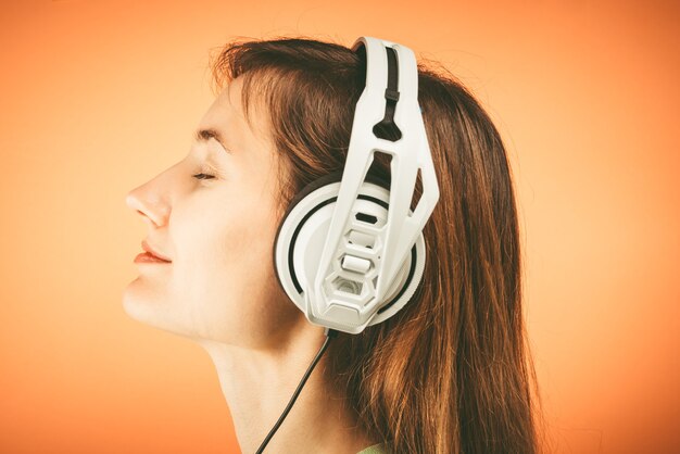 Young woman with white Musical headphones.