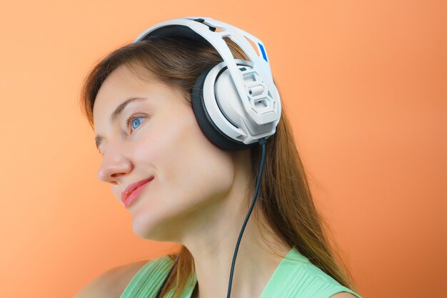 Young woman with white Musical headphones.