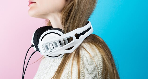 Young woman with white Musical headphones.