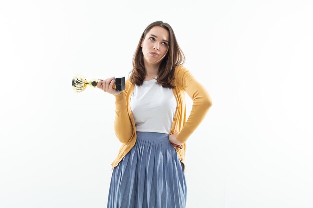 Young woman with a winning cup. Emotional portrait