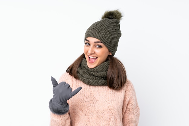 Young woman with winter hat making phone gesture