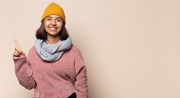 Young woman with a worried, confused, clueless expression, looking up to copy space, doubting