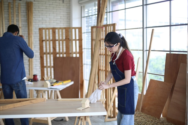 Young woman worker in the carpenter workroom