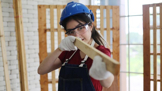 Young woman worker in the carpenter workroom