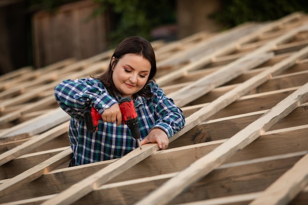 The young woman worker make frame of the roof