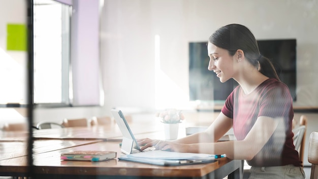 Young woman working alone at home office freelancer using laptop computer at office