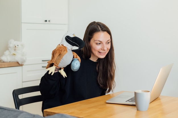 Young woman working as online nanny from home