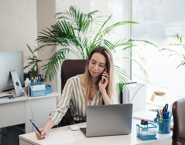 young woman working on a computer in her office