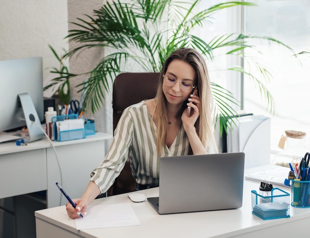 Young woman working on a computer in her office