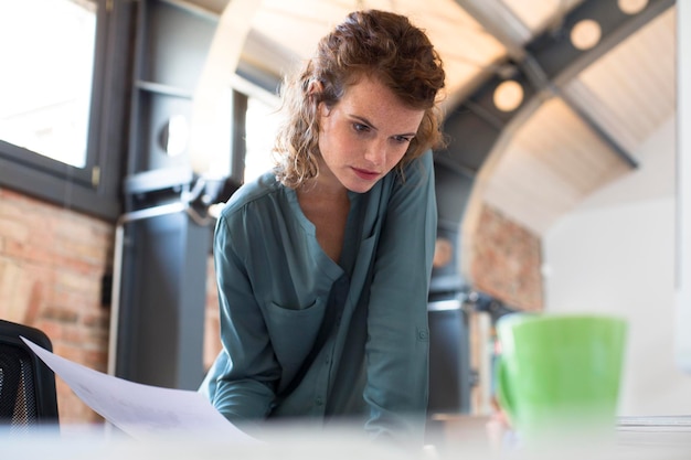 Young woman working at desk in modern office