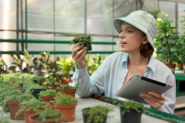 Young woman working in a greenhouse