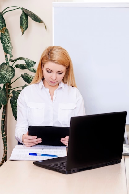 Young woman working at home and communicate with clients online.