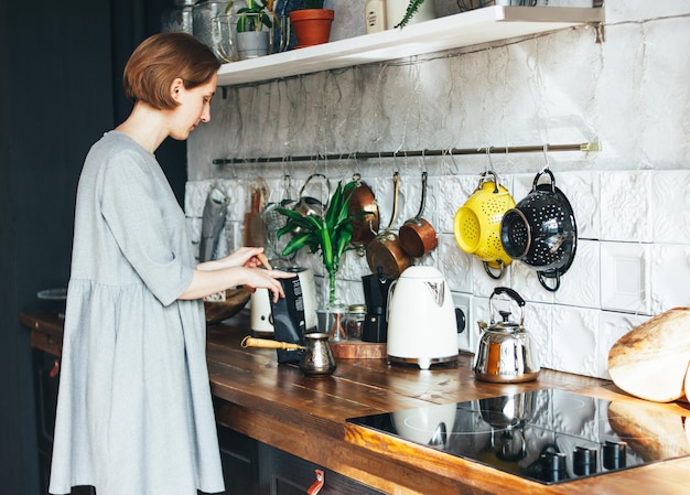Young woman working in kitchen at home