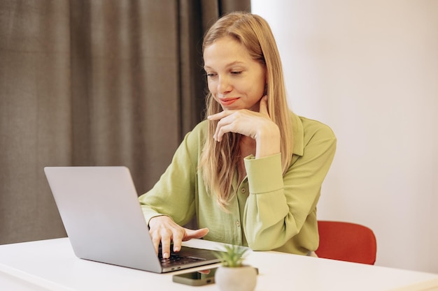 Young woman working on laptop at the desk