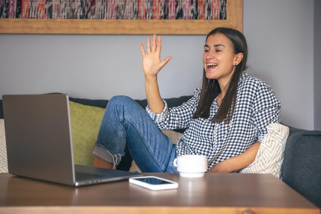 A young woman working on a laptop at home