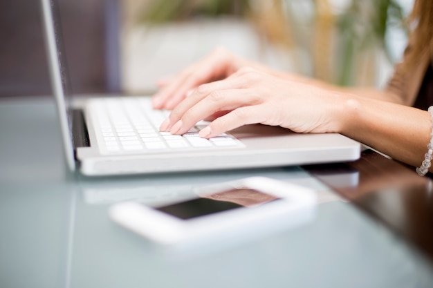 Young woman working on laptop in the room