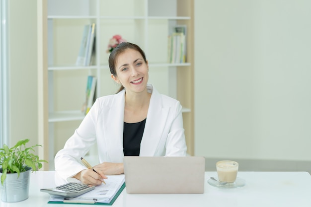 Young woman working in office with laptop