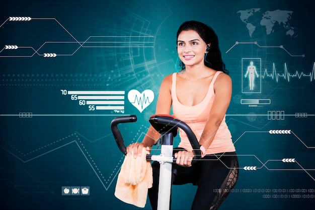 Young woman working out on exercise bike