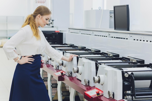 Young woman working in printing factory Printing Press