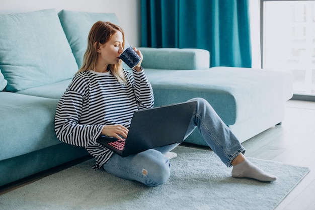 Young woman working and studying on her laptop from home