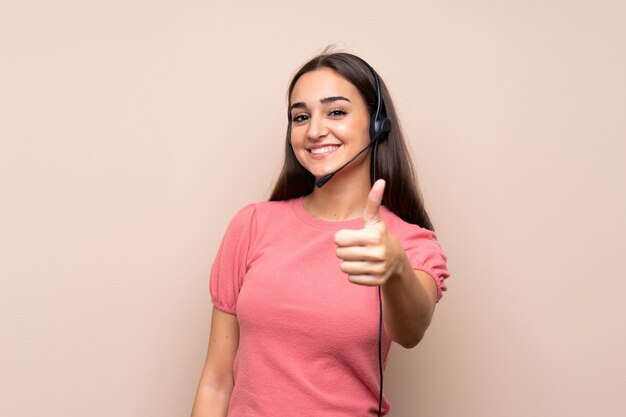 Young woman working with headset with thumb up