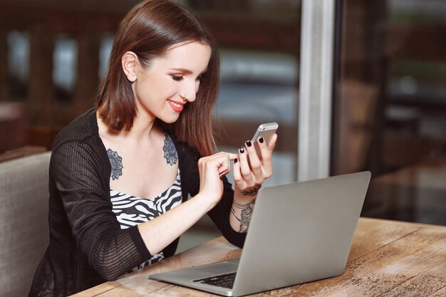 Young woman working with laptop in cafe