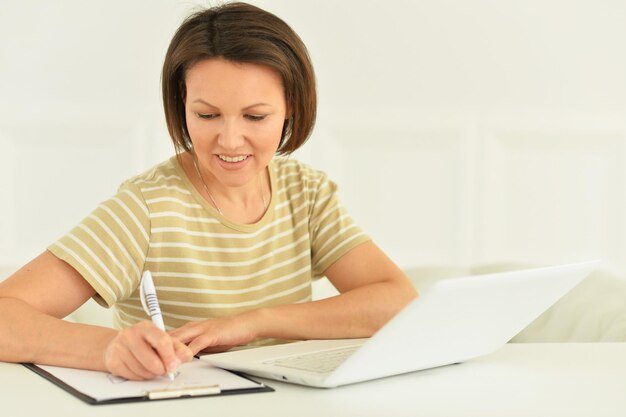 Young woman working with laptop at home