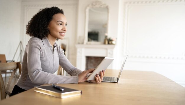 A young woman works in an office with documents uses a laptop checks a report in a finance company