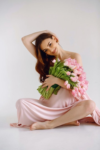 young woman wrapped in pink fabric waiting for baby birth