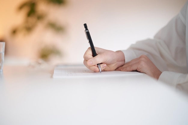 Young woman writing in notebook