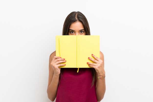 Young womanholding and reading a book