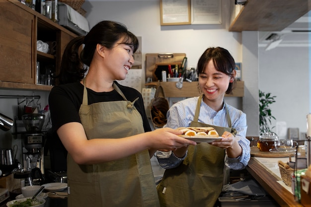 Young women arranging their cake shop