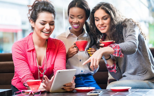 Young women in cafe taking selfie