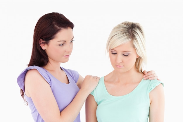 Young women comforting her friend