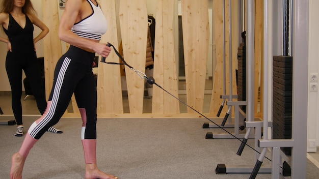 Young women doing fitness in the gym a woman doing strength exercises