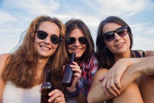 Young women drinking beer in the park