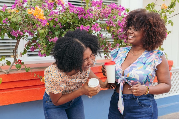 Young women drinking coffee in the street