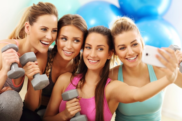 young women group taking selfie at the gym after workout