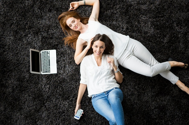 Young women laying on the carpet