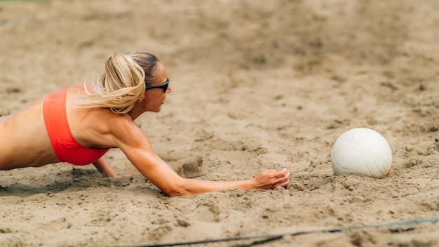 Young women playing beach volleyball